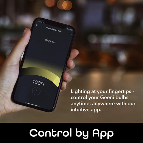 Hand holding smartphone controlling LUX Edison WiFi LED Smart Bulb 2700K Soft White via app interface.