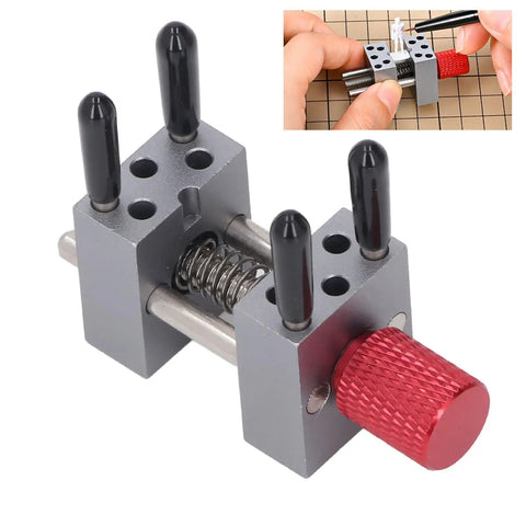 Mini Bench Vise Clamp For Jewelry Repair And Model Making Pro Grade Adjustable Parallel Jaws For Gripping Small Parts Up To 1.18 Inches Metal Silver With Protective Sleeves And 10 Holes, shown clamping a small model