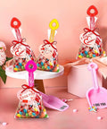 Colorful Valentine's gift bags with candy and shovels, shown with 24 Pack Beach Shovels For Kids And Adults Heavy Duty Plastic Sand Toys Set