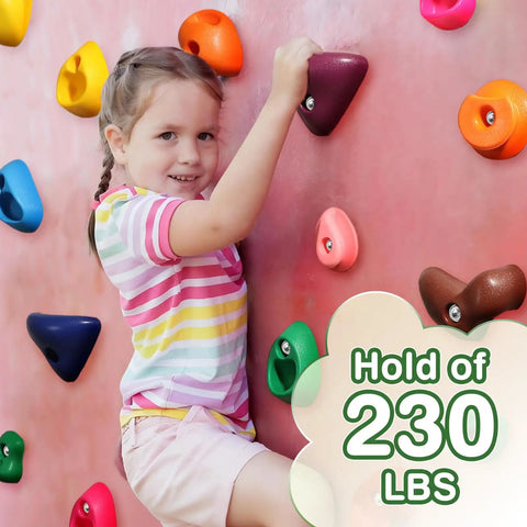 Child climbing on colorful holds of 32 Piece Rock Climbing Holds Set For Kids And Adults, with hold capacity 230 lbs.