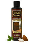 Trade Secret dark wood scratch remover bottle for nicks and scratches, 236 ml, coconut and plant extract in background