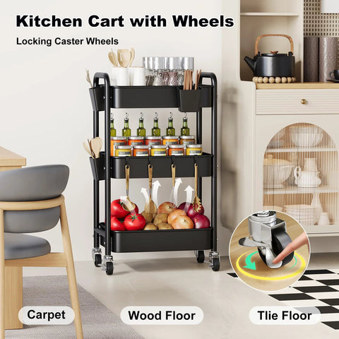 Three Tier Metal Rolling Cart On Wheels In Black in a kitchen setting with stored jars, fruits, and hooks, showcasing swivel wheels for easy mobility.