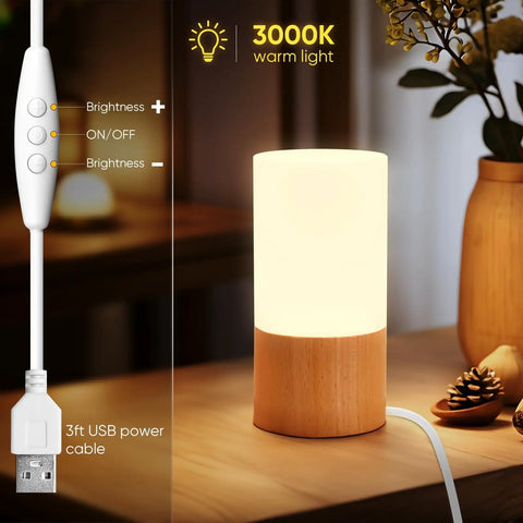 Cozy Beech Wood Table Lamp With Dimmable LED Light, USB cable, glowing warmly on a wooden surface, perfect for relaxing evenings.