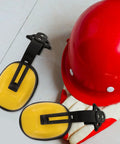 Kickass Heavy Duty Construction Hard Hat With Integrated Noise Cancelling Ear Muffs For Industrial Work Sites And Adjustable Hearing Protection laid beside red hard hat and earmuffs.