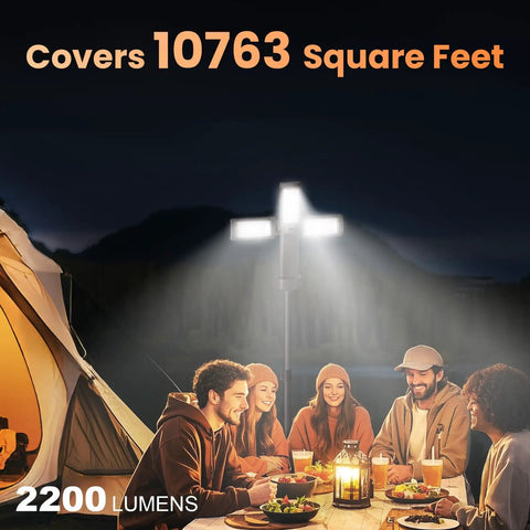 Your Go To Camping Light With Stand, Cordless LED Work Light, 2200 Lumens illuminating a group outdoors by a tent.