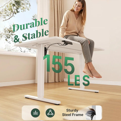 Woman sitting on 48 Inch Electric Standing Desk Height Adjustable Sit Stand Workstation With Silent Motor Memory Presets And Wide White Top.