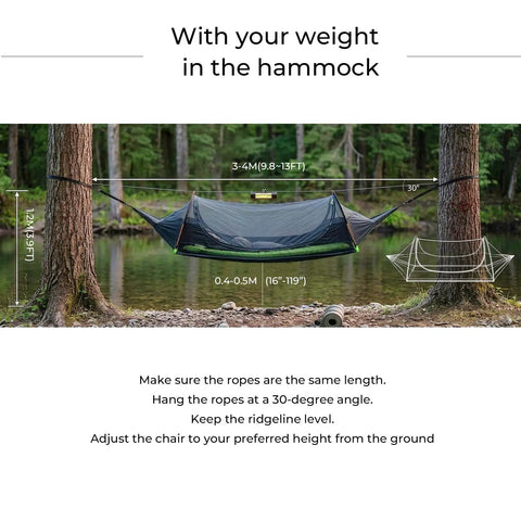 Flat Lay Camping Hammock Tent With Mosquito Net And Rain Fly 3 In 1 Waterproof Lightweight Portable Sleeping Hammock strung between trees by a lake.