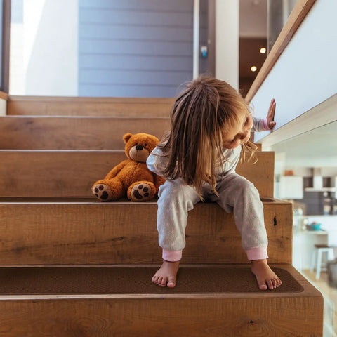 Child sitting on stairs with Skid Resistant Carpet Stair Treads Set Of 15 In Chocolate Brown 8 Inch By 30 Inch With No Slip Grip Rubber Backing.