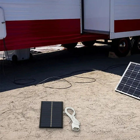 2W 6V Monocrystalline Solar Panel Charger With USB Output for outdoor lighting, placed near trailer with visible USB cable