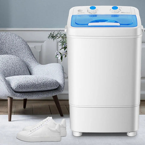 Compact Portable Washing Machine With 7.5 Liter Basin For Quick Laundry And Sneaker Scrubs next to white sneakers on a carpet.