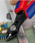 5-Inch Electronics Super Knips with Comfort Grip cutting PCBs, flush-cut design, induction-hardened 64 HRC blades visible on tool.