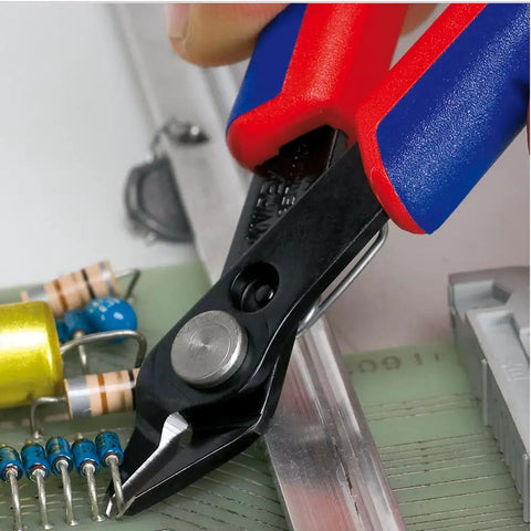 5-Inch Electronics Super Knips with Comfort Grip cutting PCBs, flush-cut design, induction-hardened 64 HRC blades visible on tool.