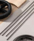 Four Pack One Quarter Inch Twenty Full Thread Stainless Steel Rod Thirty Six Inches Long on a workbench with gears.