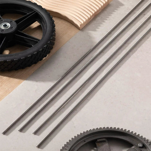 Four Pack One Quarter Inch Twenty Full Thread Stainless Steel Rod Thirty Six Inches Long on a workbench with gears.