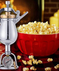 Old School Hand Crank Popcorn Cannon With Precision Pressure Gauge And Base, 1000ml Capacity, beside a bowl of popcorn.