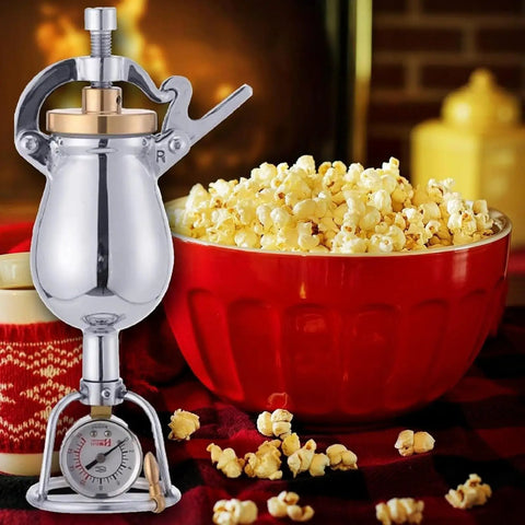 Old School Hand Crank Popcorn Cannon With Precision Pressure Gauge And Base, 1000ml Capacity, beside a bowl of popcorn.