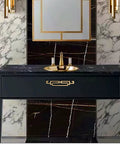 Black vanity with gold accents in a marble bathroom setting, featuring Antique Chinese Style Cabinet Pulls 4 Pack Zinc Alloy Drawer Handles.