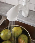 Brecklyn Glacier White One-Handle Single-Hole Kitchen Faucet with Pull-Out Sprayer Power Clean Reflex System in use over sink