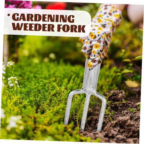 Three Prong Metal Garden Fork used for weeding in a garden bed with flowers visible, highlighting its sturdy steel design.