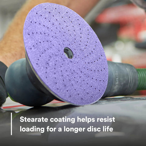 Person using Pro Grade 6 Inch 800 Plus Grit Dust Extracting Sanding Discs Pack Of 50 With Multi Hole Pattern for automotive sanding