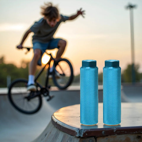 Two Pack Aluminum Alloy Bike Pegs Anti Skid For Three Eighth Inch Axles BMX Mountain Bikes Set For Street Stunts And Flatland Tricks Durable Lightweight Ride Ready Accessory displayed on skatepark ledge with BMX rider in background