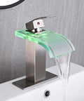 Dope LED Temperature Sensing Waterfall Vanity Faucet in Brushed Nickel with Color Changing Glow on gray wall showing water flow