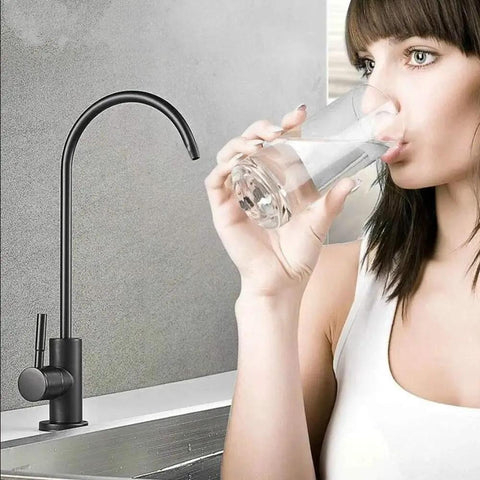Woman drinking water from matte black drinking water faucet for home RO filtration system non air gap kitchen water purifier faucet