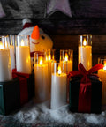 White Flameless Candles With Remote Control And Timer, 9 Piece LED Pillar Candle Set on snowy tabletop with gifts