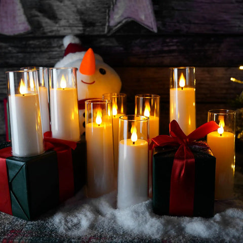 White Flameless Candles With Remote Control And Timer, 9 Piece LED Pillar Candle Set on snowy tabletop with gifts