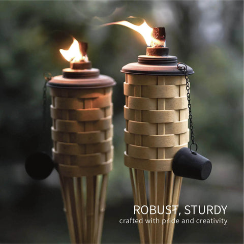 Close-up of Faux Bamboo Outdoor Torches 4 Pack Sundried Color 60 Inch Tall Island Citronella Torches lit at dusk.