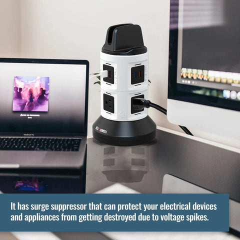 Spin Power Tower Surge Protector with 4 outlets and 6 USB ports on a desk near laptops.