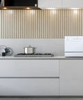 Top Notch Compact Countertop Dishwasher Fits Right Into Any Kitchen Scrubbing Dishes Clean Hassle Free With Energy Star Rating Delay Start LED Panel And Crisp White Exterior in modern kitchen with stove.