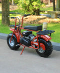 Red mini bike with beefed up header exhaust pipe kit in a park setting, compatible with Predator 212cc and GX160 clone engines.