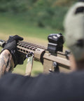 Person using a rifle outdoors wearing M-Pact 0.5mm High-Dexterity Covert Tactical Work Gloves With Touchscreen Capability, All Black, Large.