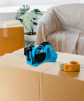 Semi Automatic Heat Tape Cutter With Compact Desktop Packing Station And Lightweight Tape Holder For Quick Box Sealing And Top Shelf Shipping Hustle The Reliable Gadget For Smooth Tape Dispensing Routine Blue on cardboard boxes.