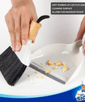 Person using Grab And Go Mini Dustpan And Brush Set With Bamboo Handle, Portable Handheld Cleaning Kit for quick cleanups.