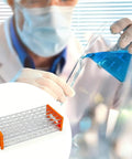 Scientist using Three Piece Plastic Test Tube Rack With Fifty Holes For Fifteen To Eighteen mm Tubes Eighteen Point Seven mm Hole Diameter Clear Acrylic Lab Rack Detachable Orange For Slick Tube Organization In School And Research Labs