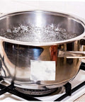 Leak Stop Tape For Pipe Repair White Insulated Waterproof Tape 1 Roll Stain Resistant And Heat Resistant 20m Length Heavy Duty Adhesive Sealant Tape For Leaks And Hoses applied on a stainless steel pot boiling on a stove.