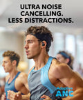 Man running indoors wearing Sport X20 True Wireless Workout Earbuds With Rotatable And Extendable Ear Hooks, Active Noise Cancellation