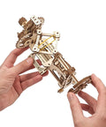 Hands holding Tachometer Model Kit For Adults, Hands On Wooden STEM Puzzle with detailed gears and mechanical components.