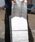 Heavy Duty Asphalt Roofing Tape That Kicks Leaks To The Curb With Heat Reflective Aluminum Foil, held upright outdoors.