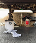 Must Have 3L Manual Transmission Fluid Transfer Pump Kit under car in use with gauge and hose attached