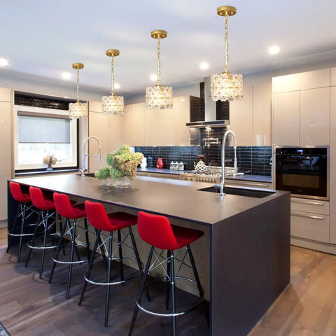 Modern kitchen featuring Dope Gold Crystal Pendant Light With Adjustable Cord, illuminating a sleek black island with red barstools.