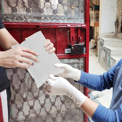 Two individuals handling a Bulk Pack Water Resistant Self Sealing Shipping Bag 25x30cm Plastic Courier Mailer in front of a gate