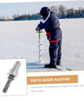 Person using All In One Drill Chuck Adapter For Rotary Hammer And Keyless Bit Converter with earth auger in snowy field.