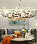 Branch Design Ceiling Pendant Light Vintage Moon Art Chandelier 9 Light Array Lowkey Stunning For Bedroom Restaurant Or Tea Room Decor Hits All The Right Vibes Durable Metal Frame above a living room couch.