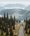 Totally Legit N Scale 1 160 Miniature Electric Transmission Tower amidst trees for model railroad dioramas and scenery.