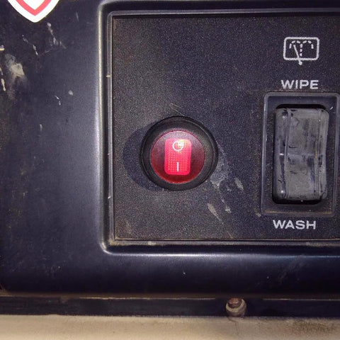 Close-up of red switch from 4 Lead LED Rock Light Wiring Harness Kit With 2 Extension Wires Relay Fuse And Switch For Offroad Pods