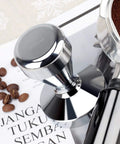 Stainless Steel Coffee Tamper 51mm Base Barista Espresso Press For Fresh Ground Beans Pro Grade Tamping Heavy Duty 570g Handle 80mm Height Ideal For Rich Even Extraction on magazine with coffee beans and portafilter.