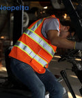 Heavy Duty Hi Vis Reflective Safety Vest For Men And Women Class Two High Visibility Work Vest With Badass Durability and Super Comfy Padded Collar For Job Sites, worn by a worker operating a forklift.